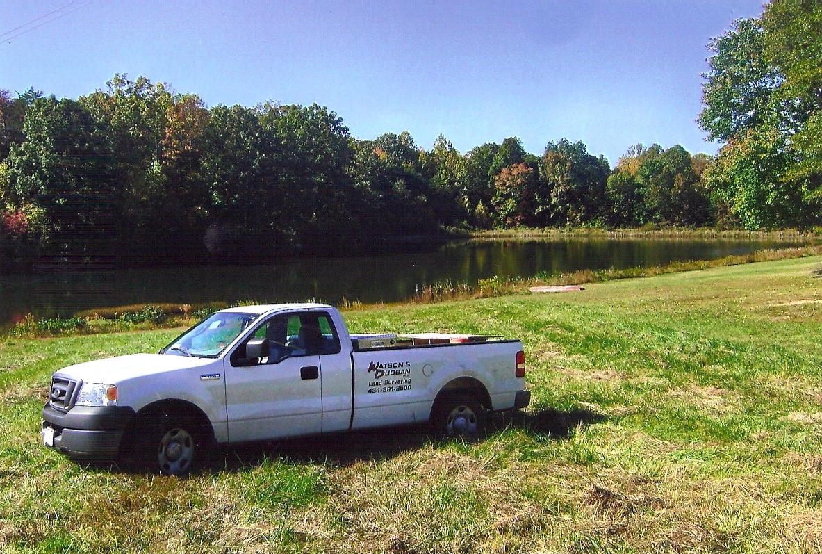 Watson and Duggan truck in front of a pond.